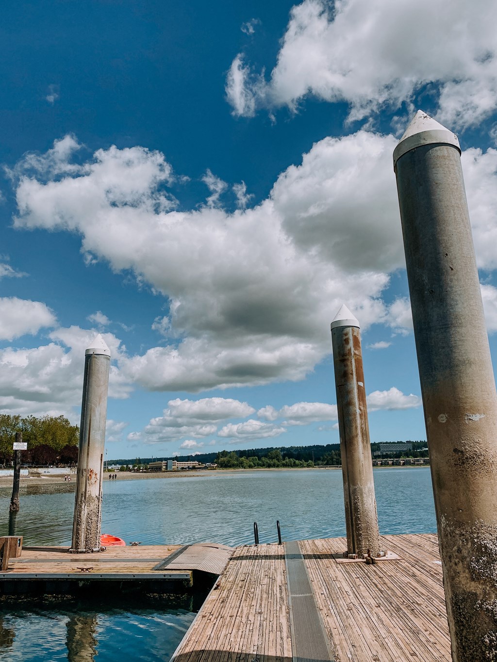 a wooden dock with three pillars on the side of it at Rivulet, Washington, 98383