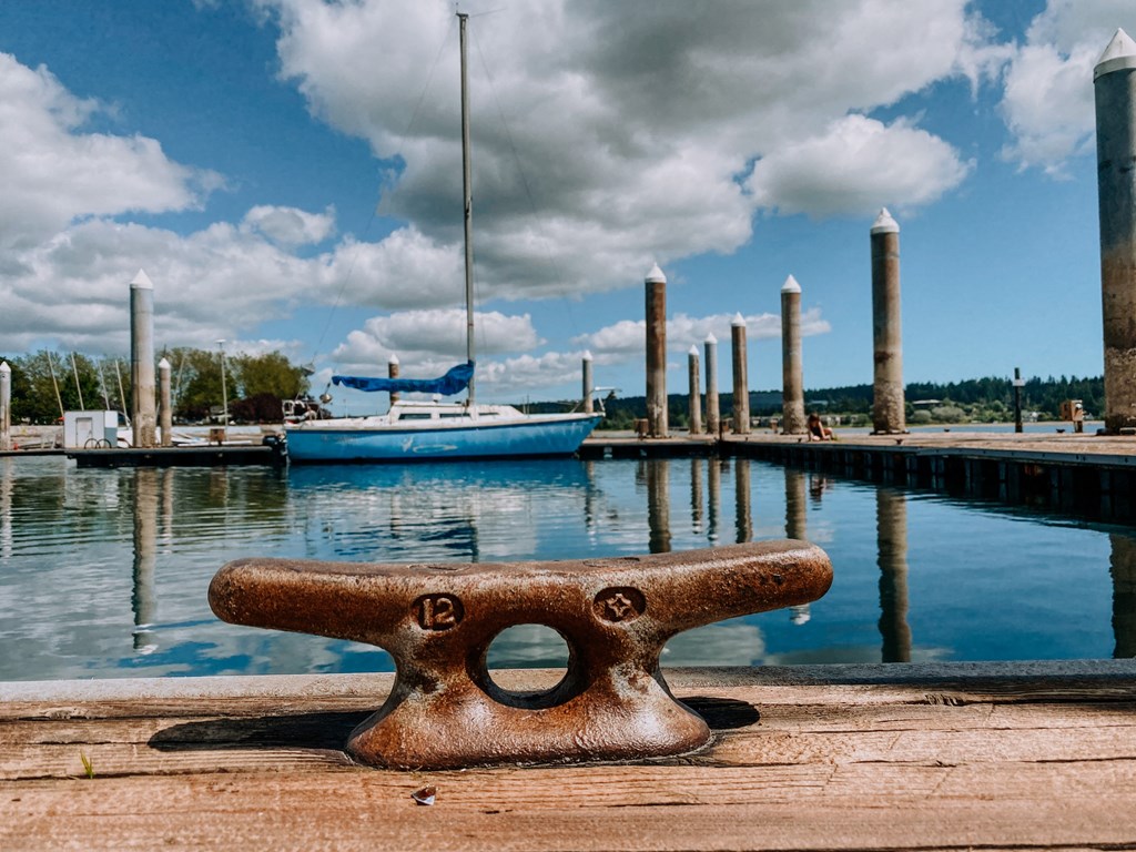 a dock with boats and clouds in the background at Rivulet, Silverdale, WA