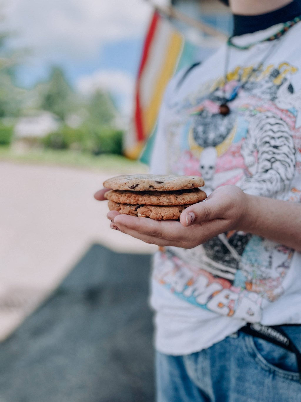 a boy in a colorful shirt holding a stack of cookies at Rivulet, Silverdale, Washington