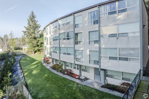 A modern building with a green lawn in front.