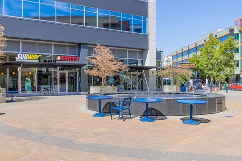 A Subway restaurant is located in a plaza with tables and chairs  at Spyglass Hill Apartments, Bremerton, 98337