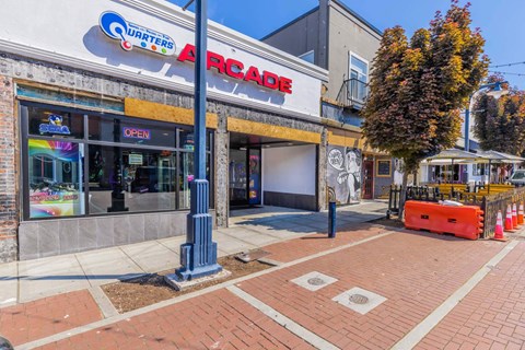 A brick sidewalk leads to a closed arcade  at Spyglass Hill Apartments, Bremerton, 98337
