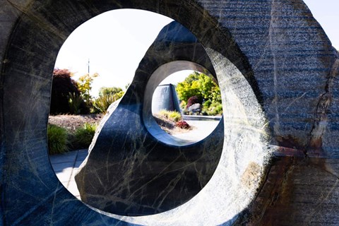 A person is walking through a circular stone structure  at Spyglass Hill Apartments, Bremerton, 98337