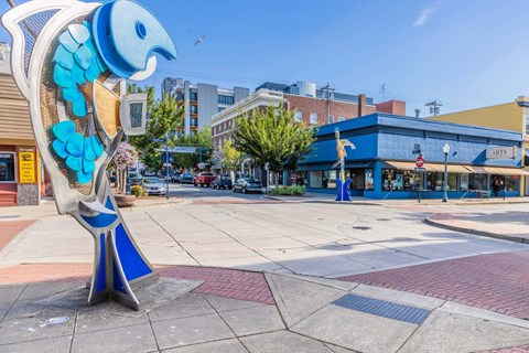A blue and white bird statue is in the middle of a plaza  at Spyglass Hill Apartments, Bremerton, 98337