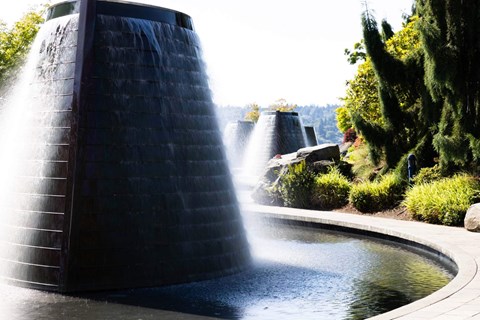 A water fountain with a tall, dark structure shooting water upwards  at Spyglass Hill Apartments, Bremerton, 98337