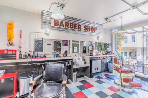 A barber shop with a checkered floor and a red and black chair  at Spyglass Hill Apartments, Bremerton, 98337
