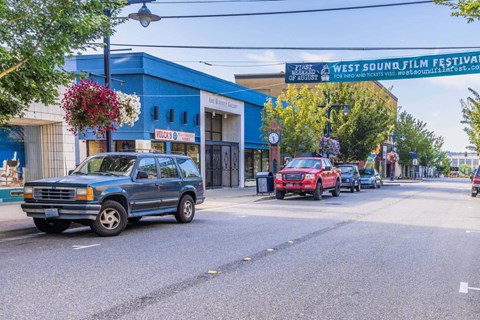 A blue car is parked on the side of the street  at Spyglass Hill Apartments, Bremerton, 98337