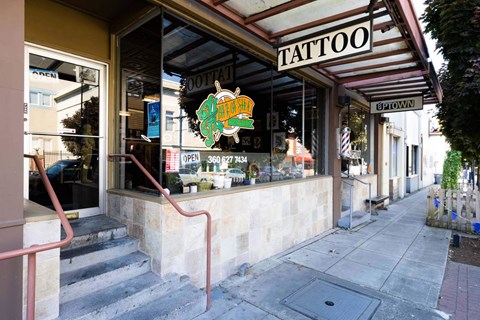 A tattoo shop with a sign that says  at Spyglass Hill Apartments, Bremerton, 98337