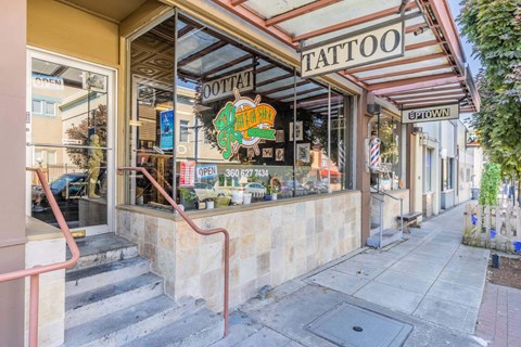 A tattoo shop with a red staircase leading to the entrance  at Spyglass Hill Apartments, Bremerton, 98337