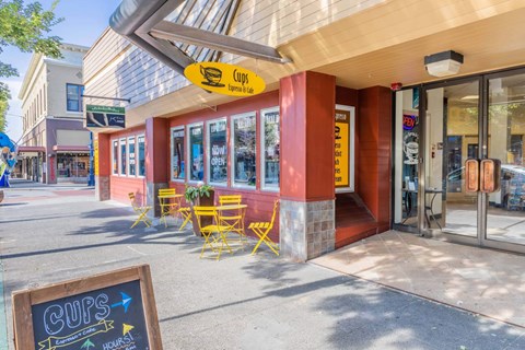A storefront with a yellow chair outside and a sign that says  at Spyglass Hill Apartments, Bremerton, 98337