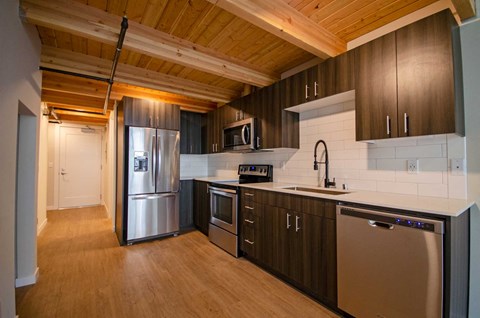 A kitchen with wooden cabinets and stainless steel appliances.