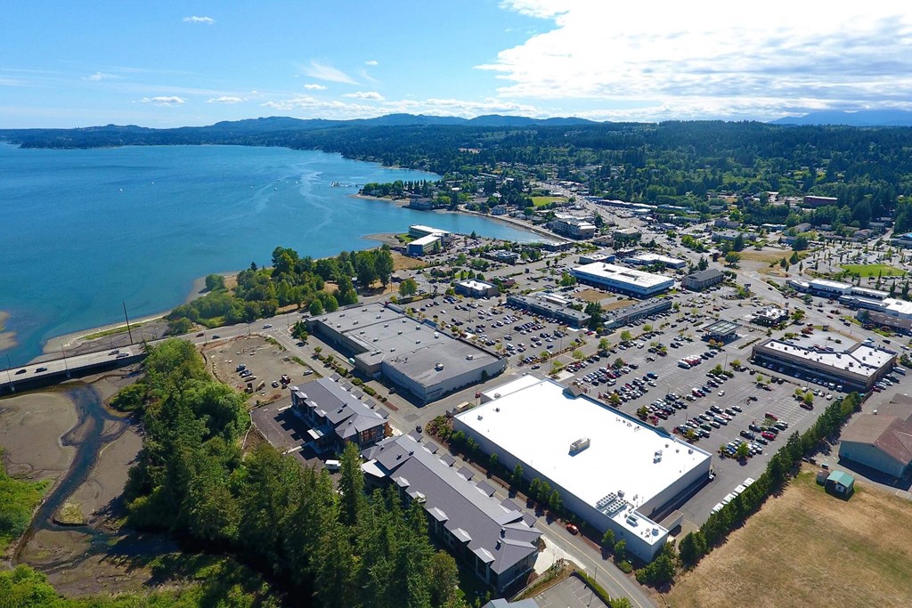 an aerial view of a parking lot with a lake in the background at Rivulet, Silverdale, Washington