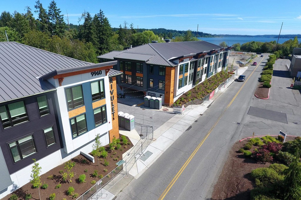 an aerial view of a building with a lake in the background at Rivulet, Silverdale, 98383