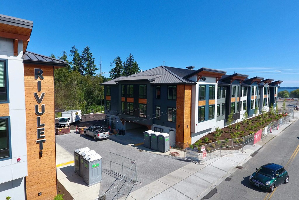 a row of buildings with a blue sky in the background at Rivulet, Silverdale, 98383