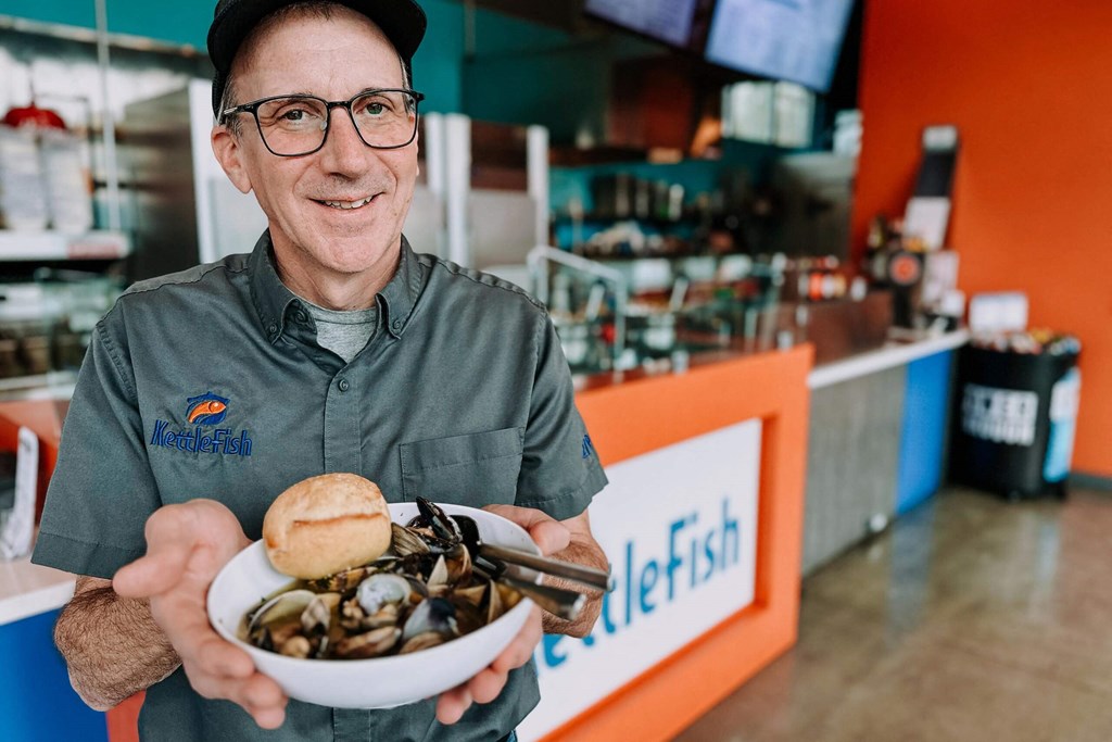 a man holding a bowl of clams at Rivulet, Washington