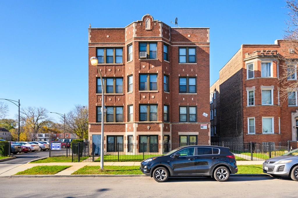 a car parked in front of a brick building