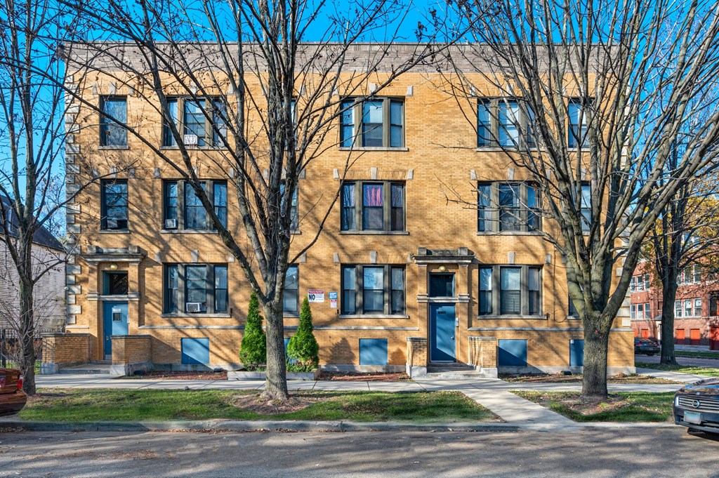 a large brick building with trees in front of it