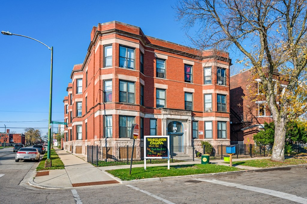 a red brick building on the corner of a city street
