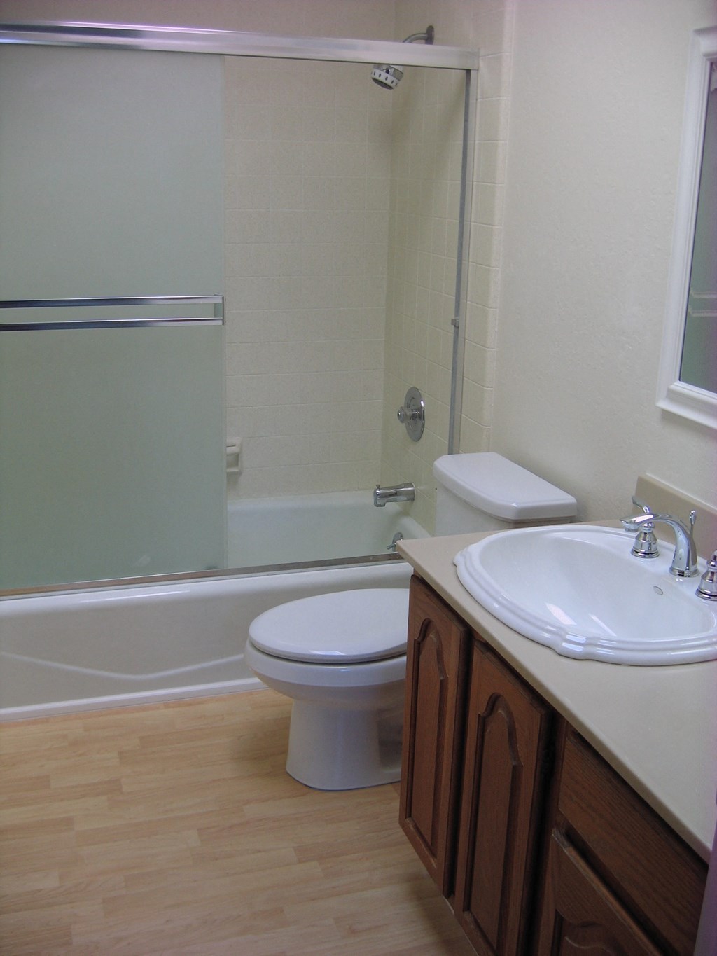 a bathroom with a toilet and a sink and a shower