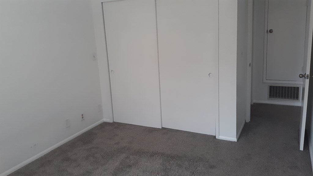 A room with white walls and a carpeted floor.