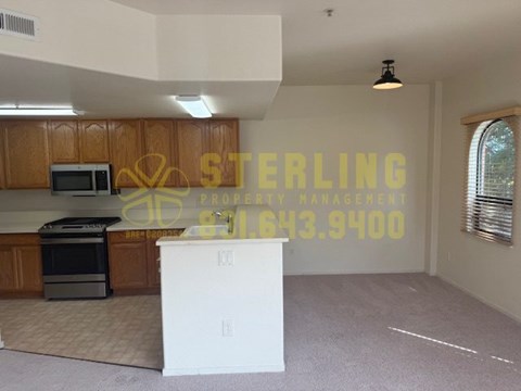 A Sterling Property Management office is set up in a kitchen area.