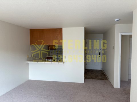 A room with a carpeted floor and a wooden panel on the wall.