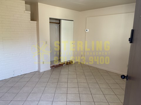 A room with a Sterling Property Management logo on the wall.
