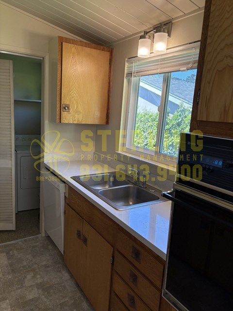 A kitchen with a washing machine and a dishwasher.