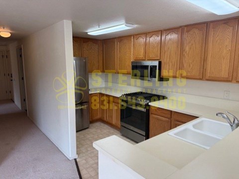 A kitchen with wooden cabinets and a white countertop.