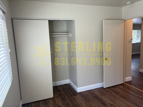 A Sterling Property number is displayed on the wall of an empty room.