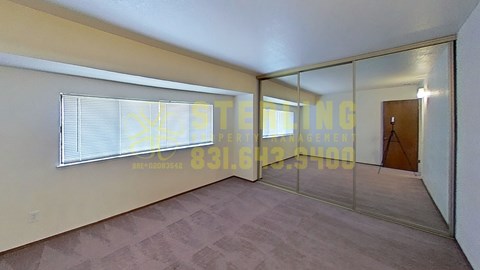 A room with a glass wall and a door is available for rent.