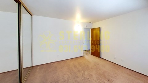 A room with a door and a wall with a logo on it.