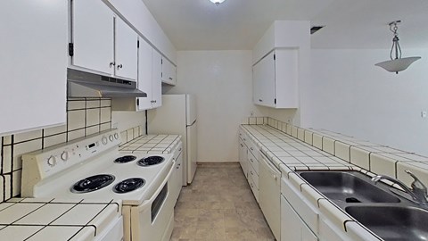 A kitchen with white appliances and cabinets.