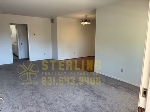 A Sterling Property Management logo is displayed on a wall in an empty room.