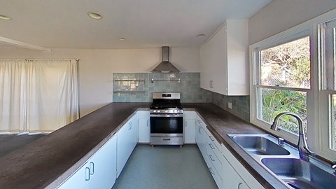 a kitchen with a stove and a sink