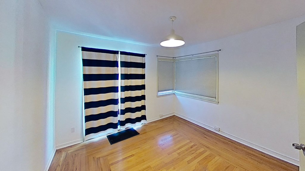 a living room with a window and a curtain