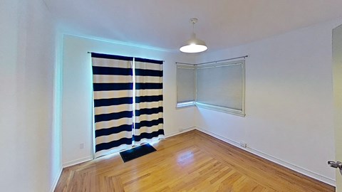 a living room with a window and a curtain