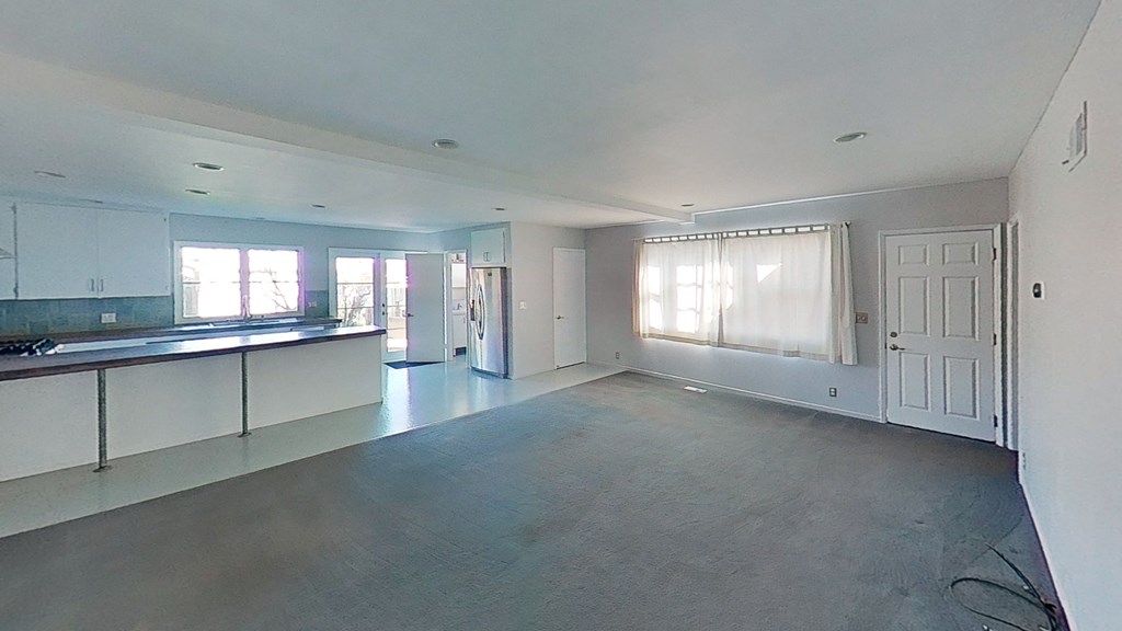 an empty living room and kitchen in a new home