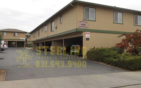 A building with a sign that says "STERLING PROPERTY MANAGER" and a phone number.