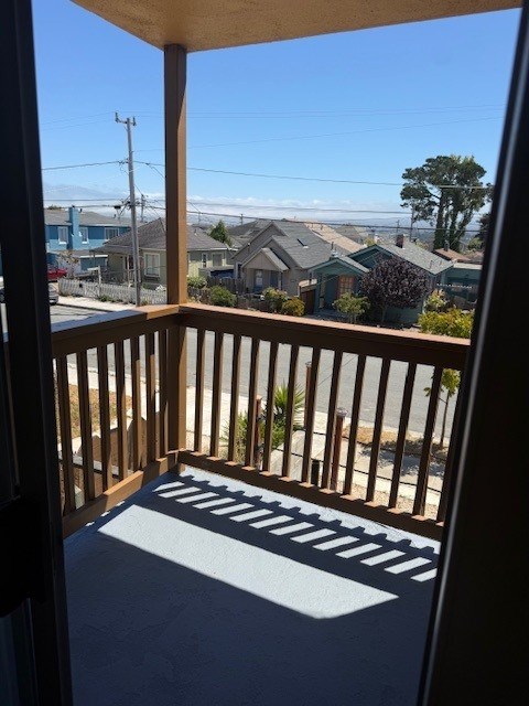 A balcony with a yoga mat on the floor.