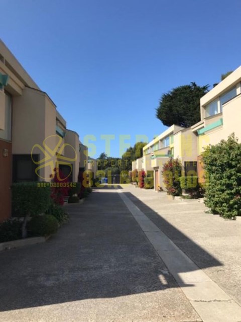 A street view of a residential area with houses on both sides.