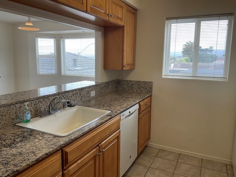 A kitchen with a sink and a window.