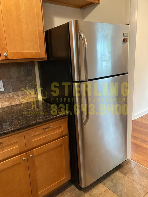 A stainless steel refrigerator in a kitchen.