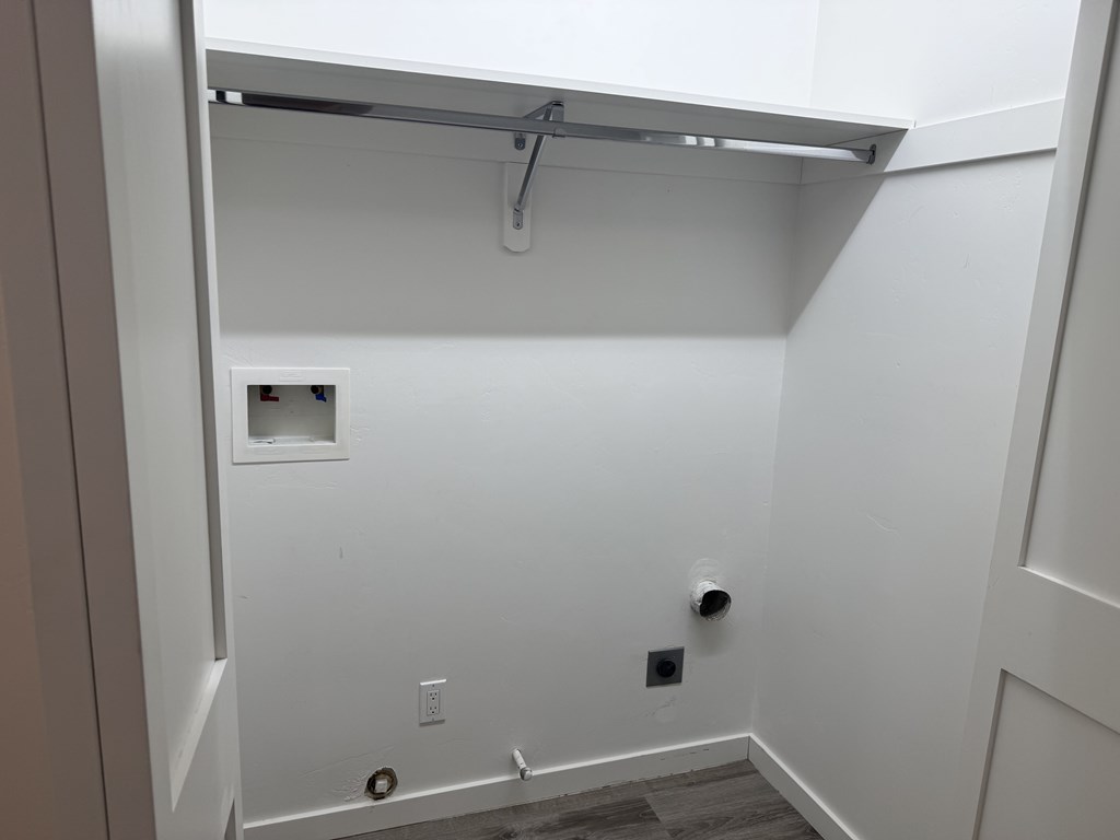 A white bathroom with a shower and a toilet.