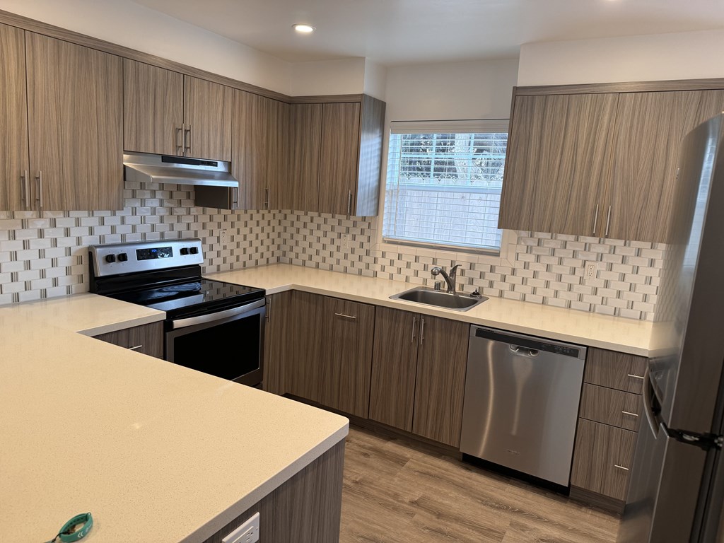 A kitchen with a stove top oven and a dishwasher.