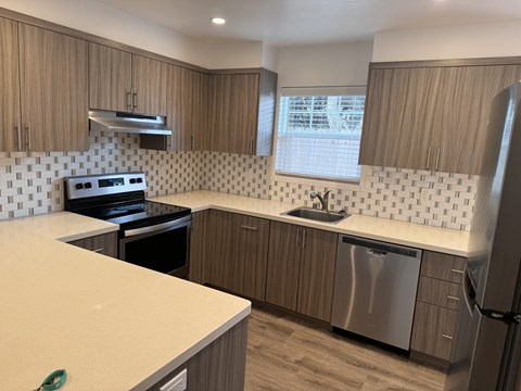 A kitchen with a stove top oven and a dishwasher.