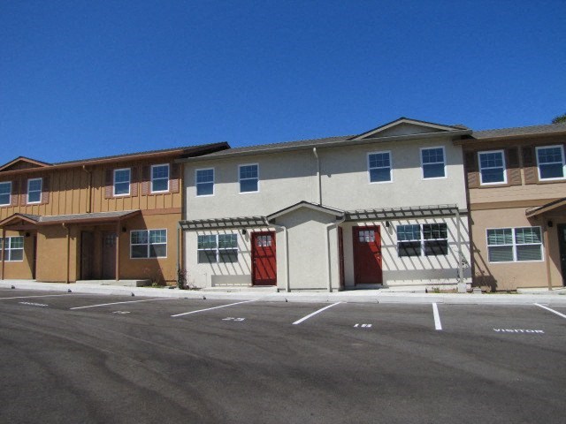a building with red doors in a parking lot