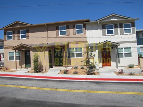 A two story house with a brown and white exterior.