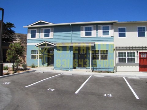 A blue and white building with a yellow sign on the front.