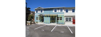 A blue and white building with a yellow sign on the front.